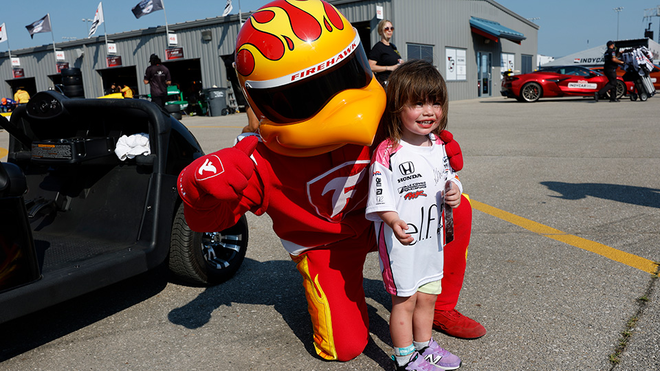 A child poses with Firestone Firehawk